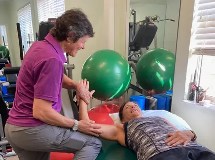 Manual therapy being applied to a patient's shoulder